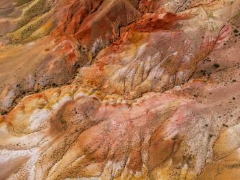 Aerial drone view of the textured yellow and red mountains resembling the surface of land, nature landscape in popular tourist location called Mars, near the border with Mongolia, Chagan-Uzun, Altai Republic, Russia