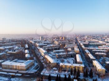 Aerial view of the colorful frosty winter evening and residential areas in Barnaul.