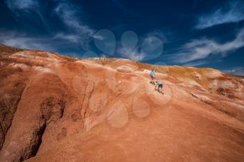 Woman with her son in valley of Mars landscapes in the Altai Mountains, Kyzyl Chin, Siberia, Russia