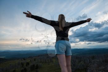 Travel, lesure and freedom concept - woman on the top of Altai mountain, beauty summer evening landcape