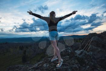 Travel, lesure and freedom concept - woman on the top of Altai mountain, beauty summer evening landcape