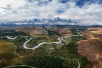 Kurai steppe and Chuya river on North-Chui ridge background. Altai mountains, Russia. Aerial drone panoramic picture.