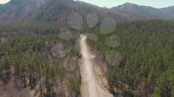 Aerial view of a road in summer landscape, in Altai mountains, cinematic drone footage