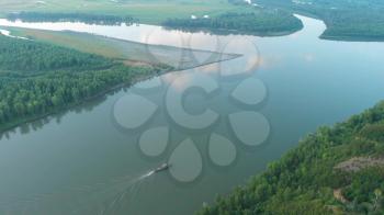 Aerial view of big siberian Ob river with boat in beauty summer evening, 4K drone footage.