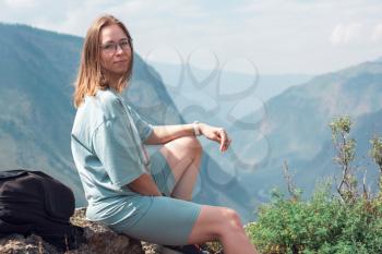Woman on the top of Altai mountain, Katu Yaryk mountain pass and the valley of the river of Chulyshman, beauty summer day landcape. Travel, leisure and freedom concept
