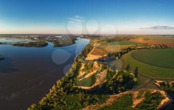 Aerial drone view of river landscape in sunny summer evening. Top view of siberian Ob river from high attitude in summer sunset. Panorama, bird's eye view