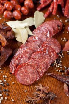 different sausage and meat on a celebratory table with spices and vegetables