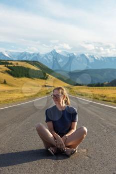 Woman om the Chuysky trakt road in the Altai mountains. One of the most beautiful road in the world.