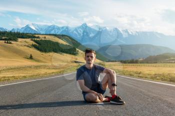 Man on the Chuysky trakt road in the Altai mountains. One of the most beautiful road in the world.