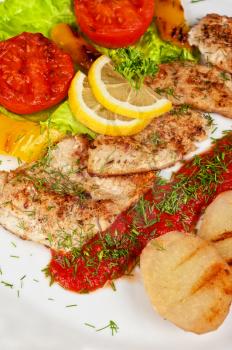 Tasty fish pike perch fillet with vegetables and sauce