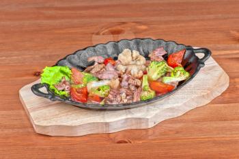 meat with vegetables at frying pan