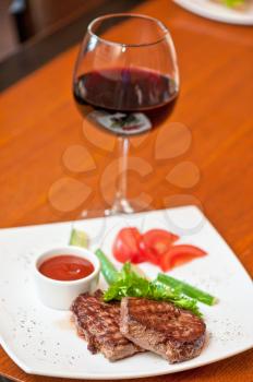 grilled beef steak with sauce and wine