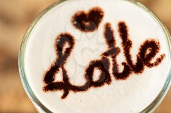 closeup of glass with latte in a cafe