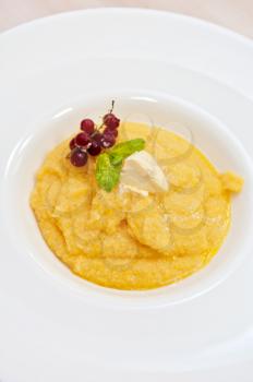 Corn porridge with berry closeup