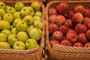 Counter with ripe apples in supermarket 