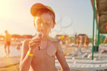 Baby boy with ice-cream at the beach