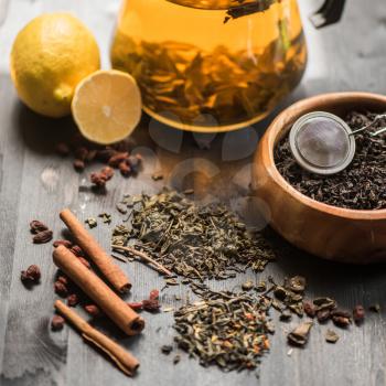 tea composition with cinnamon sticks, lemons