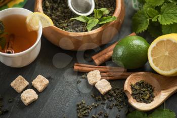 tea composition with cinnamon sticks, lemons