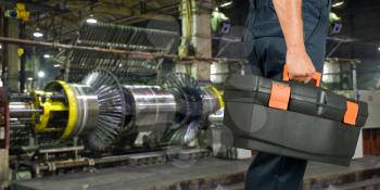 Worker with instruments at industrial factory