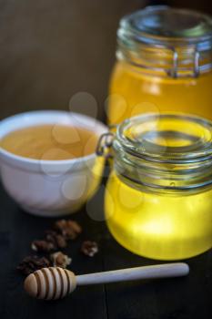 Honey with walnut on wooden background