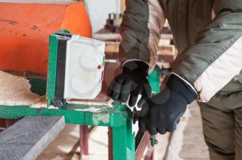 Carpenter working at sawmill, closeup photo