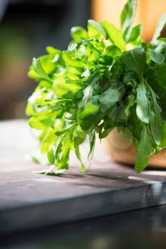 Fresh organic rucola leaves on a wooden table