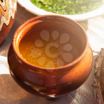 Honey with walnut on wooden background