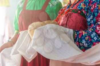 Russian old-fashioned wedding. Hands with bread, meeting with guests