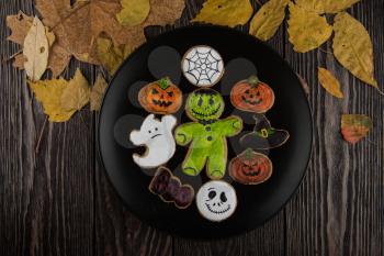 Homemade delicious ginger biscuits for Halloween on wooden table