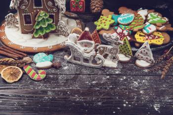 Homemade gingerbreads for new year holiday on dark wooden background, xmas theme