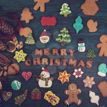 Different ginger cookies for new years and christmas on wooden background, top view