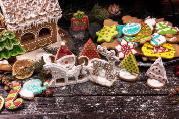 Different ginger cookies for new years and christmas on wooden background