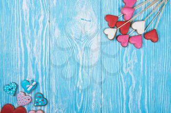 Gingerbreads for Valentines Day or wedding theme on blue wooden background