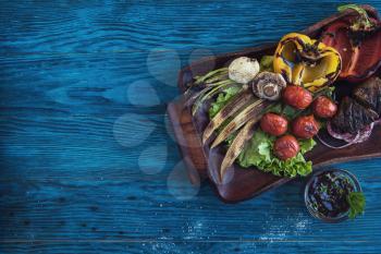 Grilled vegetable on a blue wooden background