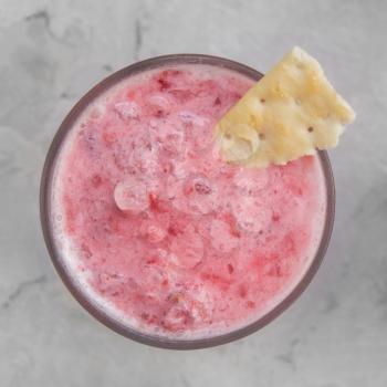 Strawberry smoothie with cookie on a white concrete background. Square cropping