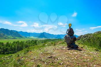 Monument of faceless boy in mountains in Karakol valley, Altay, Siberia, Russia