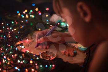 Boy writes a letter to Santa, cristmas background