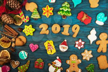 Gingerbreads cookies for new 2019 year holiday on wooden background, xmas theme