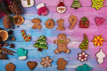 Gingerbread cookies for new 2019 year on wooden background, xmas theme