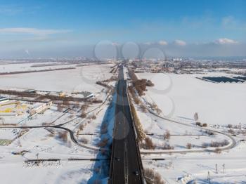 Aerial view of a road with traffic in winter landscape