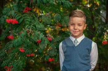 The first time in first class: happy schoolboy at school background