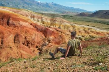 Relaxing man in Valley of Mars landscapes in the Altai Mountains, Kyzyl Chin, Siberia, Russia