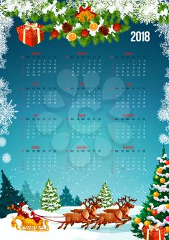 2018 New Year calendar with Christmas tree and gift decoration. Festive calendar template, framed by Xmas tree, bell, snowflake and Santa sleigh with snowy landscape of winter forest on background