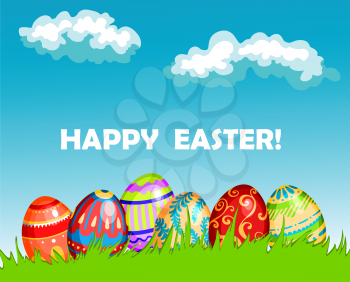Colourful Happy Easter greeting card design with a row of decorated Easter Eggs in fresh green spring grass under a blue sky with fluffy white clouds and the text