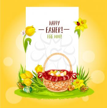 Easter Egg Hunt basket floral greeting card with copy space. Happy Easter and Egg Hunt greetings on blank paper, supplemented with Easter eggs, flowers of tulip and narcissus, basket on green grass