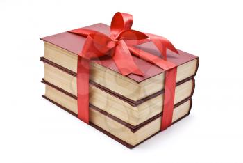 Pile of books with red ribbon and bow 