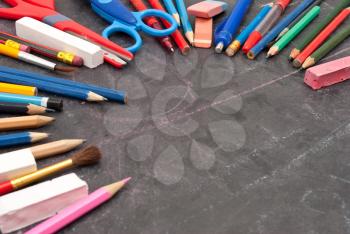 Chalkboard with school tools