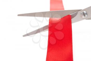 Scissors cutting red ribbon 