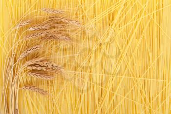 Ears of wheat on a background scattered spaghetti