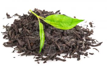 Heap of dry black tea with green tea leaves